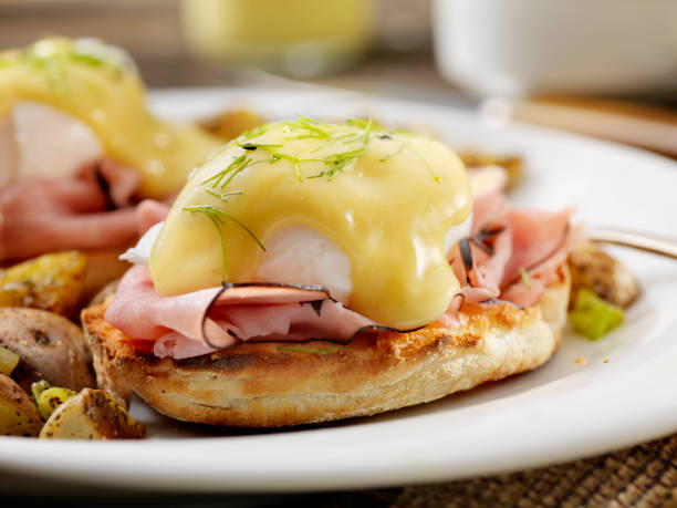 Eggs Benedict with Black Forest Ham and Hash Browns Eggs Benedict with Black Forest Ham and Hash Browns hollandaise sauce stock pictures, royalty-free photos & images