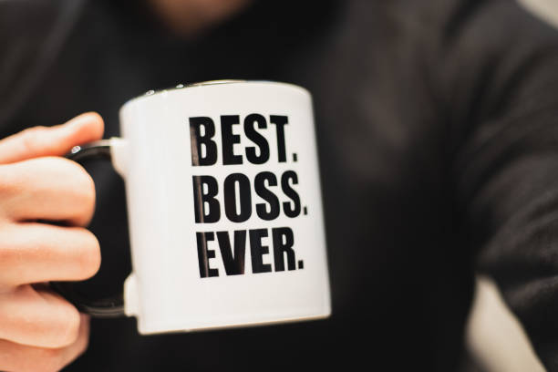 a man holding a coffee mug with best boss ever printed on it. - vanity business business person men imagens e fotografias de stock