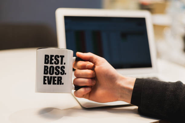 istock A man holding a coffee mug with best boss ever printed on it. 1153522182