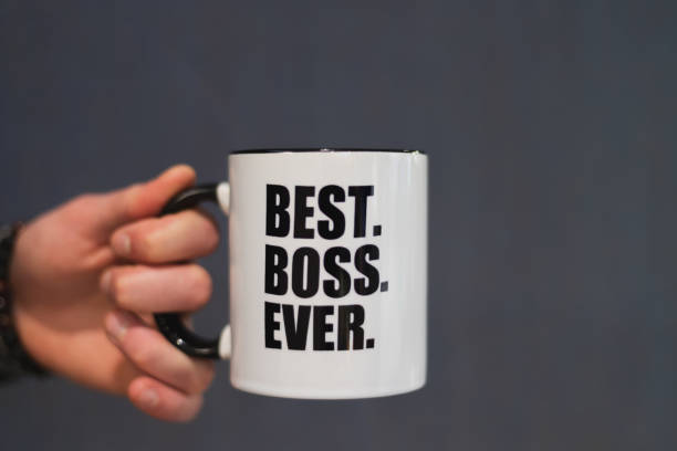 istock A man holding a coffee mug with best boss ever printed on it. 1153522193