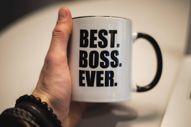 istock A man holding a coffee mug with best boss ever printed on it. 1153522202