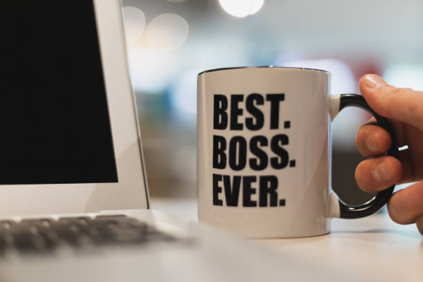 istock A man holding a coffee mug with best boss ever printed on it. 1153522298