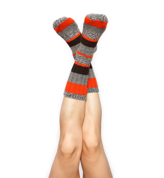 istock Female feet in warm socks 1153522441