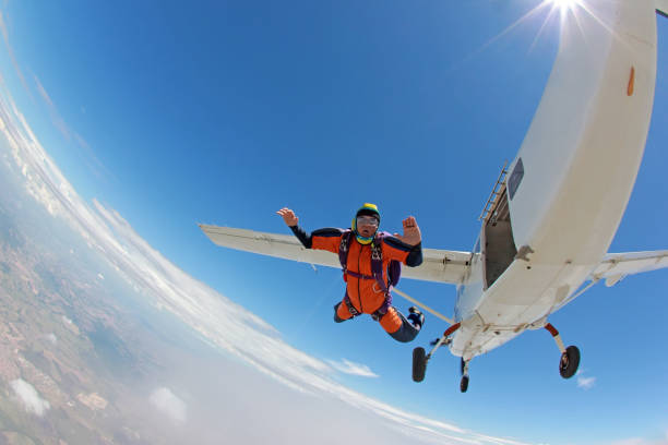 vecchio paracadutista che salta su un aereo. - skydiving parachuting extreme sports airplane foto e immagini stock