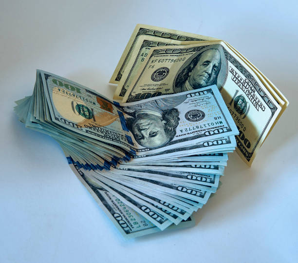 istock Stack of one hundred dollar bills new design on a white background 1153528553