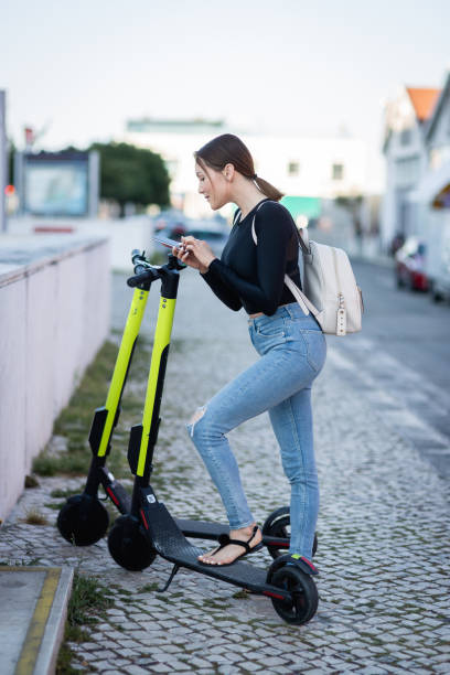 istock A woman using a mobile phone for unlocking an electric scooter by app 1153528607