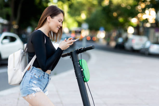 istock A woman using a mobile phone for unlocking an electric scooter by app 1153528615