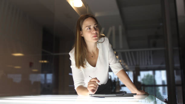 istock Young woman writing on her tablet 1153530180