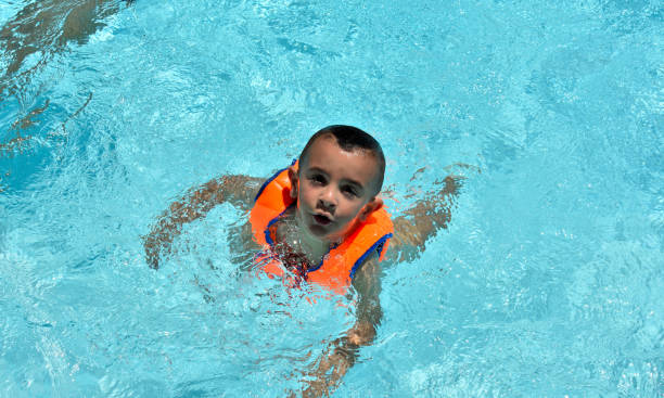 istock Happy children swimming in the pool 1153531082
