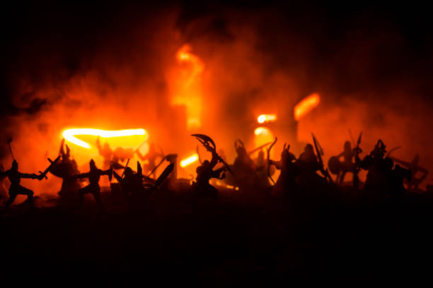 istock Medieval battle scene with cavalry and infantry. Silhouettes of figures as separate objects, fight between warriors on dark toned foggy background with medieval castle. 1153535247