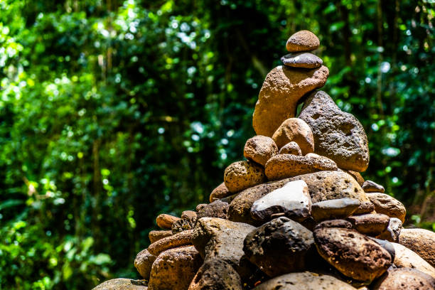 A Cairn is a pile or formation of rocks created by humans. This pile of rocks was found on a hike on the Hawaiian island of Kauai.