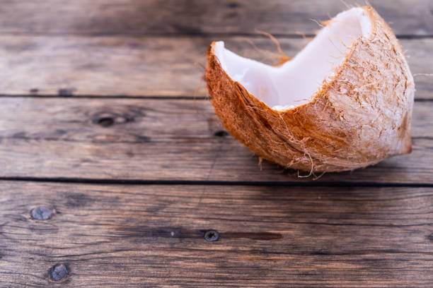 istock Open Coconut On Wooden Table Background 1153539944