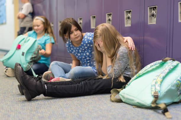 A friend consoling her friend at an elementary school