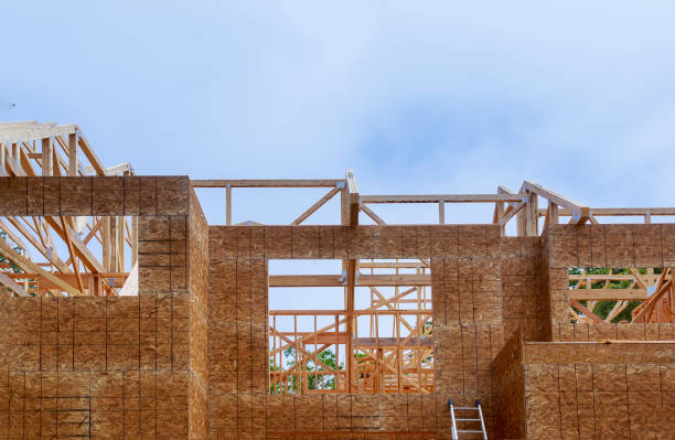 istock Looking up new construction beams under a clear blue sky with sunlight 1153541387
