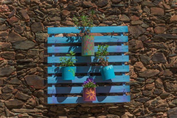 istock Geranium pots in bluish recycled cans 1153542245