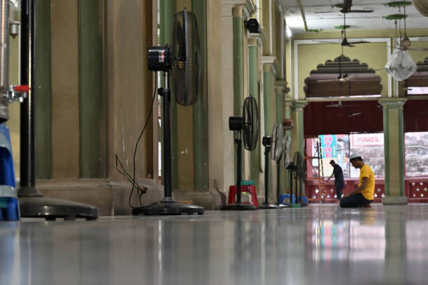 KOLKATA, WEST BENGAL, INDIA - MAY 27 2019 : Young Muslim devotee praying at Nakhoda Masjid, one of the oldest Masjids of Kolkata. Public place of historial and religious value for Indian citizens.