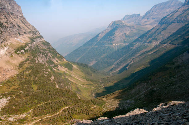 Glacier National Park - Highline Trail seen from Logan Pass, with the Going to the Sun Road also scratched into the mountain.  The haze comes from forest fires.