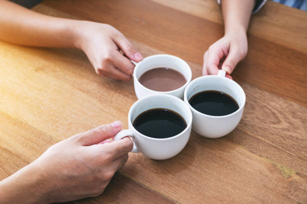 istock people clinking coffee cups on wooden table in cafe 1153555307