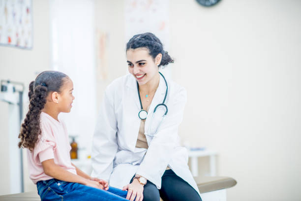 istock Doctor comforts little girl 1153555309