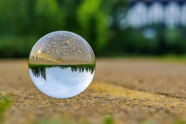 A unique view of a lensball on the ground in the springtime