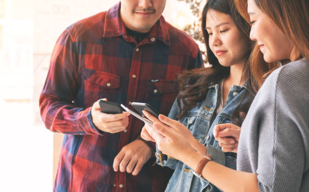 istock asian people using and looking at mobile phone and tablet pc together 1153562485