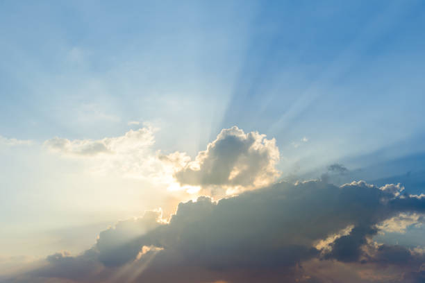 istock Beautiful dramatic sky clouds with light rays at sunset. Natural landscape for background 1153566565