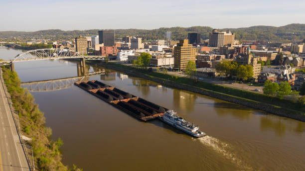 istock Barge Pushes Resources Down the River in Front of Charleston West Virginia 1153571635