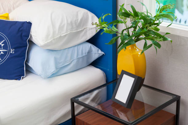 modern teen bedroom green plant pot and table lamp in teen bedroom. red cushion covers stock pictures, royalty-free photos & images