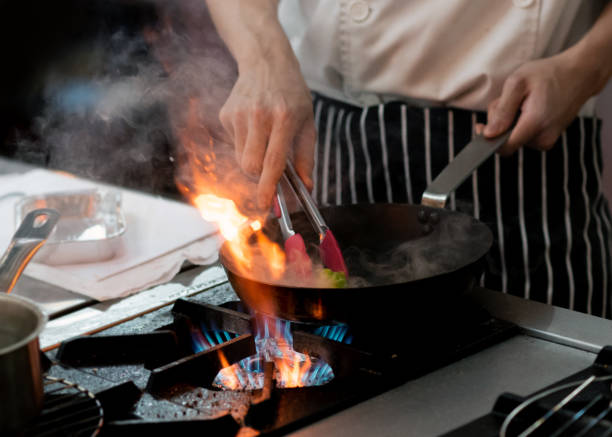 istock Chef preparing food in the kitchen, chef cooking, closeup 1153571825