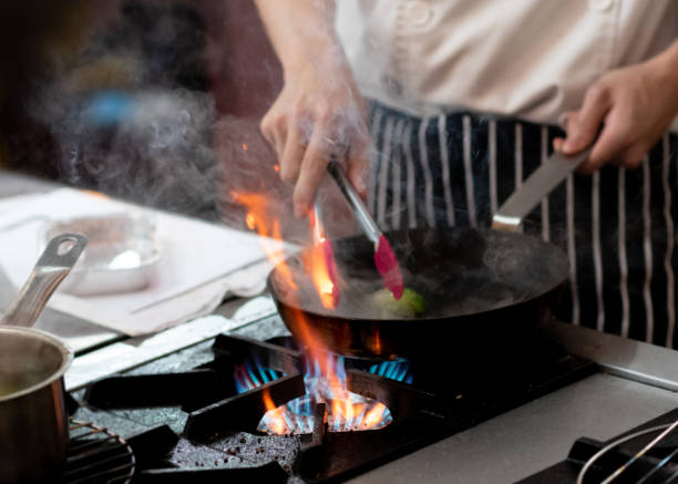 istock Chef preparing food in the kitchen, chef cooking, closeup 1153571835