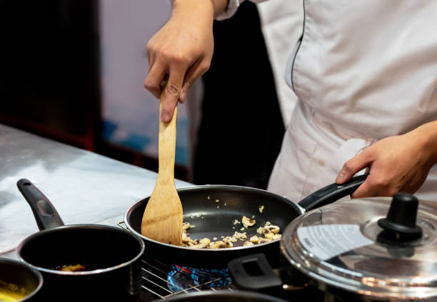 istock Chef preparing food in the kitchen, chef cooking, closeup 1153571841