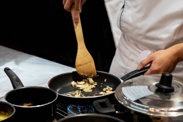 istock Chef preparing food in the kitchen, chef cooking, closeup 1153571843