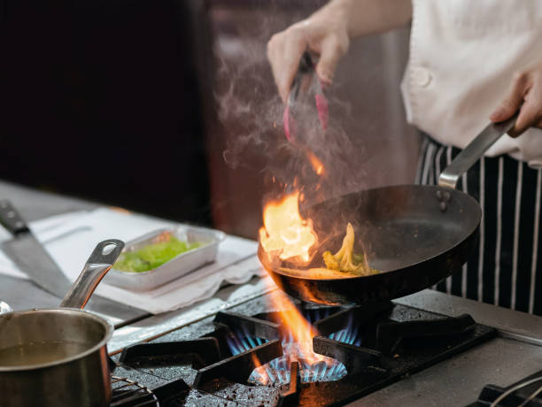 istock Chef preparing food in the kitchen, chef cooking, closeup 1153571844