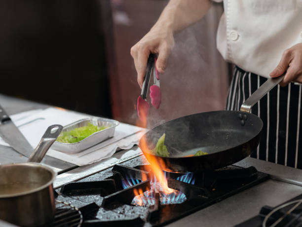 istock Chef preparing food in the kitchen, chef cooking, closeup 1153571858