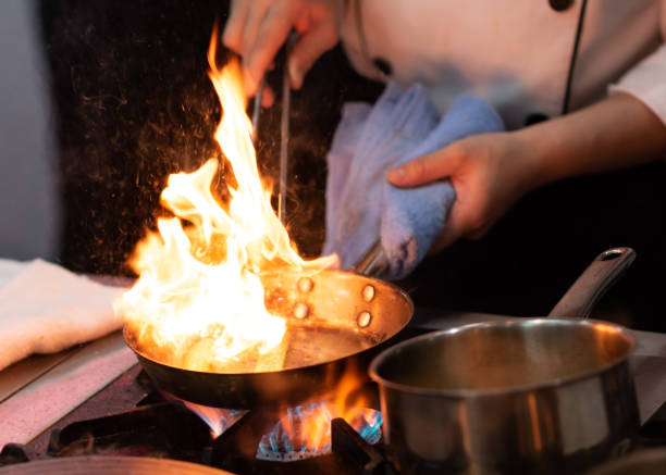 istock Chef preparing food in the kitchen, chef cooking, closeup 1153571898