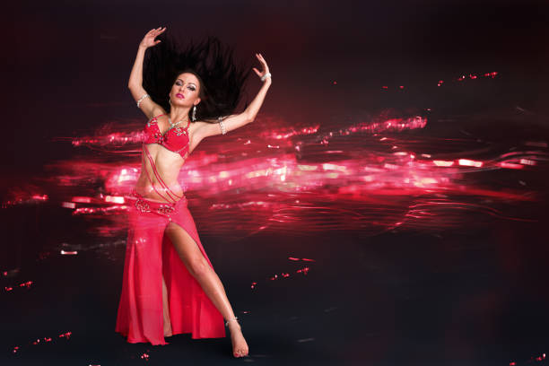 istock Young woman performing belly dance 1153574348