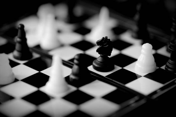 istock Travel Chess on a dark background close up. Black and white 1153577448