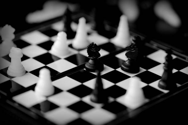 istock Travel Chess on a dark background close up. Black and white 1153577466