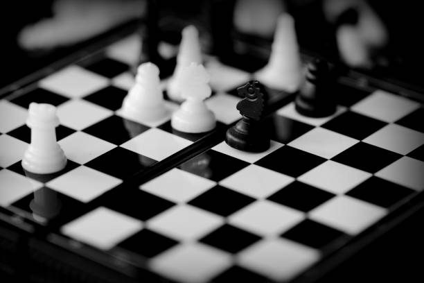 istock Travel Chess on a dark background close up. Black and white 1153577468