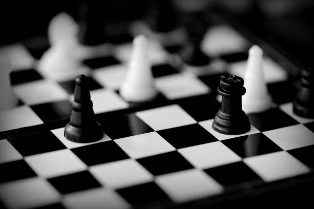 istock Travel Chess on a dark background close up. Black and white 1153578067