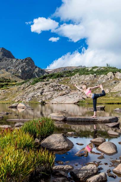 istock Female yoga mountains lake 1153579570
