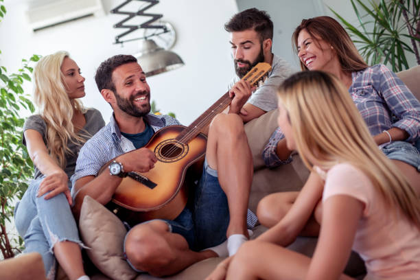 istock Cheerful friends enjoying together at home 1153582573