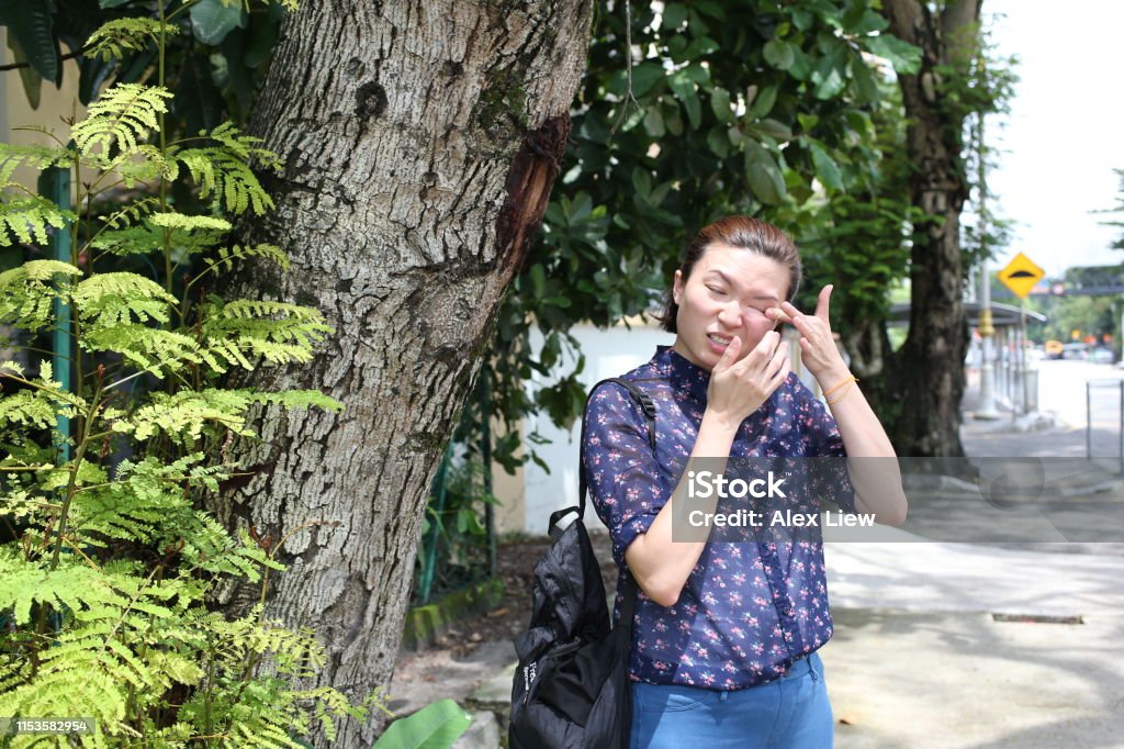 Living with Allergies - Itchy Eye A lady cannot help from rubbing her itchy eye. 30-39 Years Stock Photo