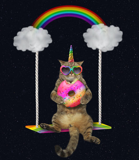 istock Cat unicorn with a donut swinging 1153585339