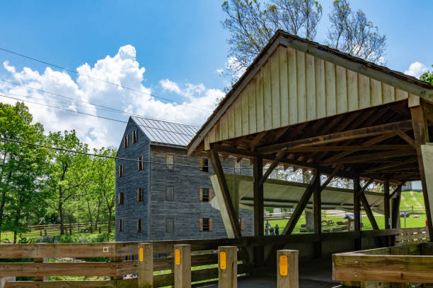 Rock Mill Covered Bridge Lancaster, Ohio/USA-May 18, 2019: Rock Mill Covered Bridge in the foreground with the, 5 1/2-story Rock Mill gristmill in the background. old flour mill stock pictures, royalty-free photos & images