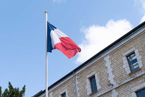 french flag at the top of a mat in a barracks blue white red