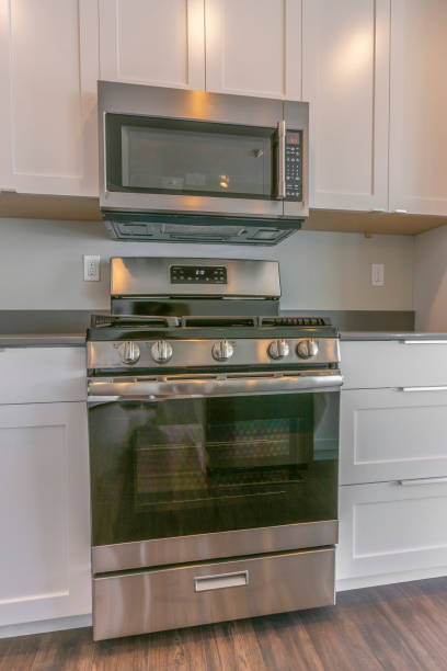 istock Range and wall mounted microwave inside the modern kitchen of a new house 1153587301