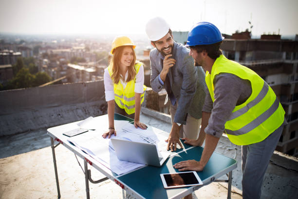 istock Team of architects people in group on construciton site check documents and business workflow. 1153591228