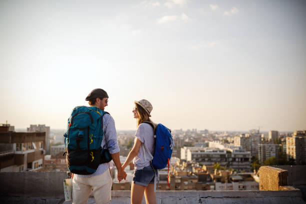istock Multiethnic traveler couple using map together on sunny day 1153591784