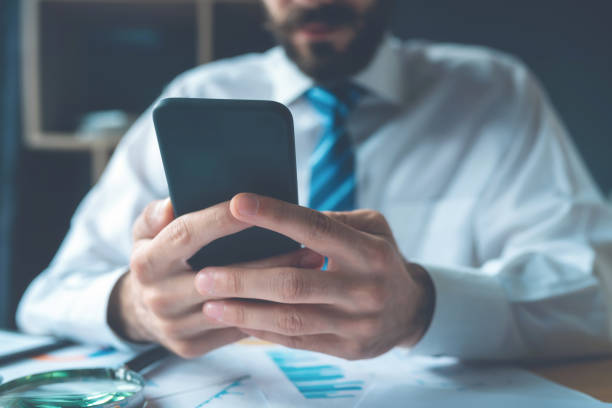 istock Business man hand are using cell phones in office 1153592223